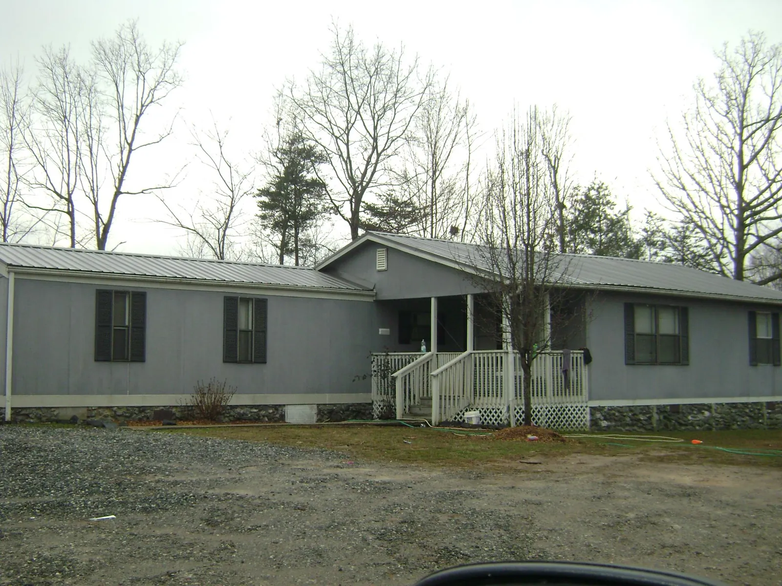 Metal roof over a manufactured home with a covered front porch in Fort White